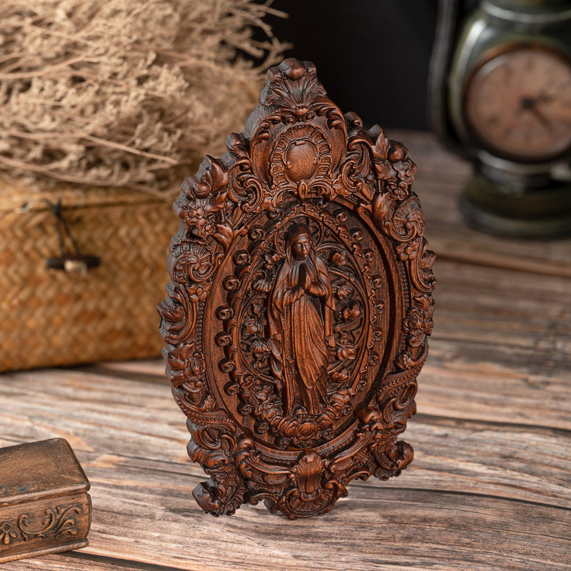 Wood carving of the Virgin Mary in leaves