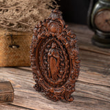 Wood carving of the Virgin Mary in leaves