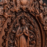 Wood carving of the Virgin Mary in leaves