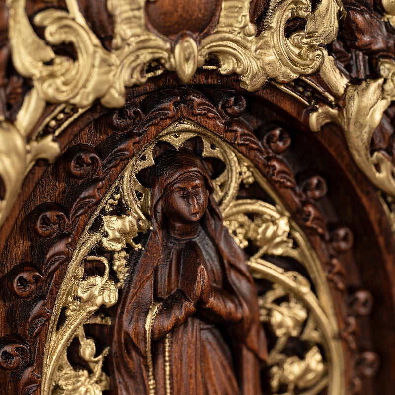 Wood carving of the Virgin Mary in leaves