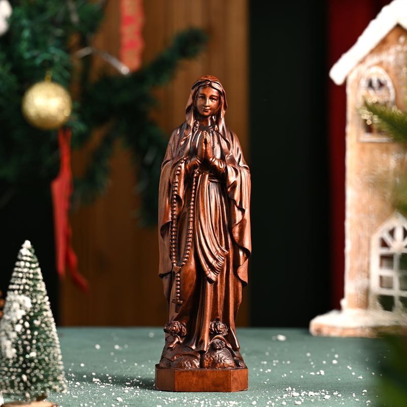 Wooden statue of Our Lady of Lourdes praying