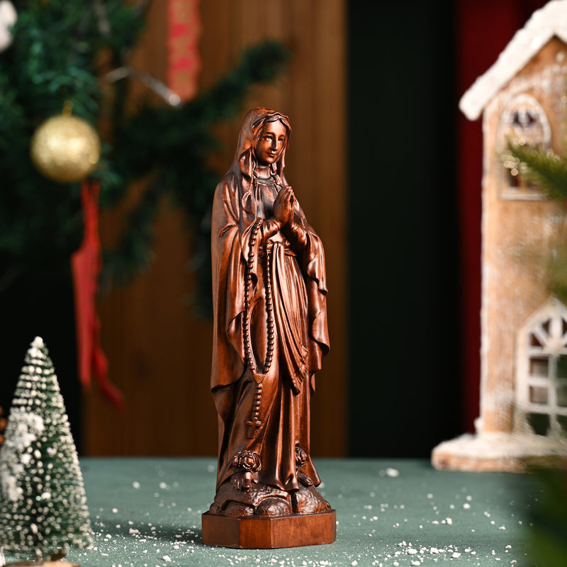 Wooden statue of Our Lady of Lourdes praying