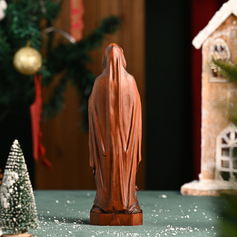 Wooden statue of Our Lady of Lourdes praying