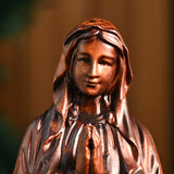 Wooden statue of Our Lady of Lourdes praying