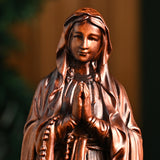 Wooden statue of Our Lady of Lourdes praying