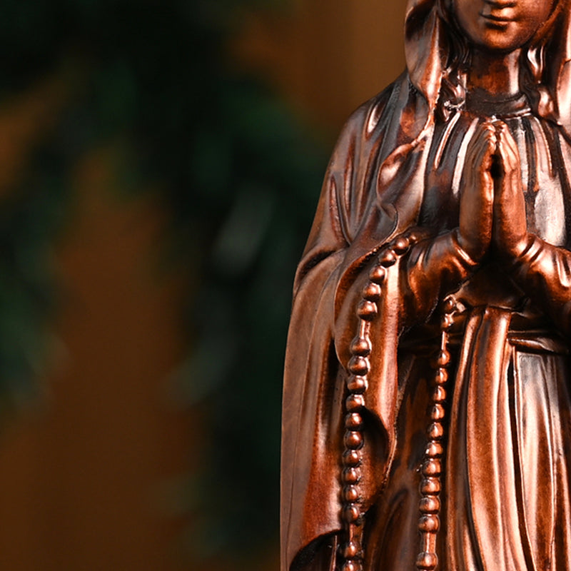 Wooden statue of Our Lady of Lourdes praying