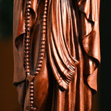 Wooden statue of Our Lady of Lourdes praying