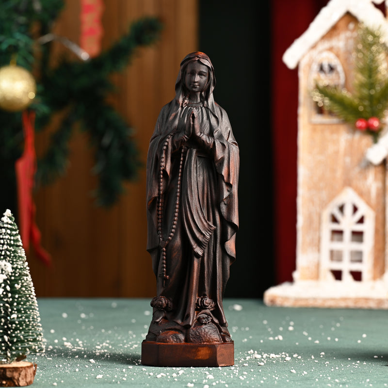 Wooden statue of Our Lady of Lourdes praying